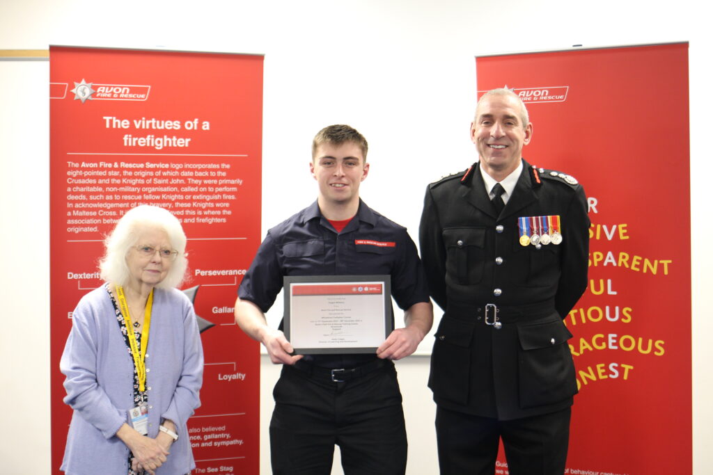 Firefighter Fergus Williams with certificate