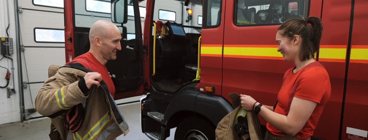 Firefighters beside a fire appliance