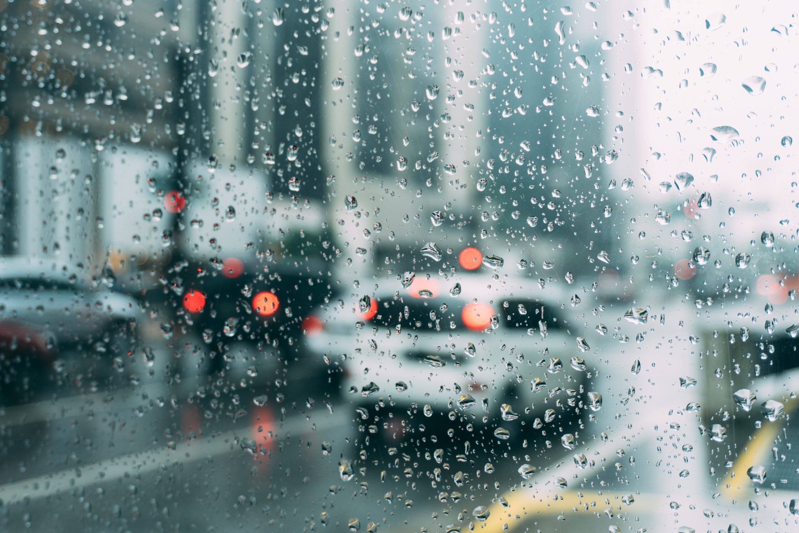 photo out of a car window driving through the rain.