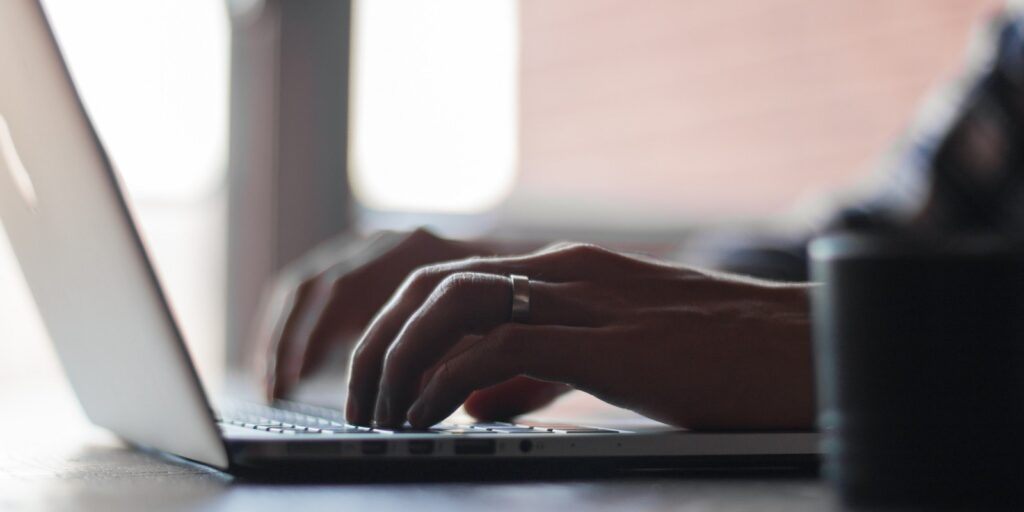 hands typing on laptop