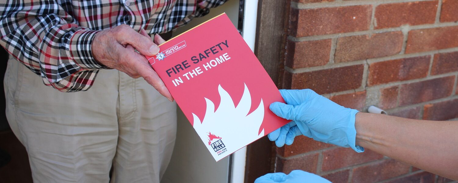 home fire safety booklet being handed over to resident