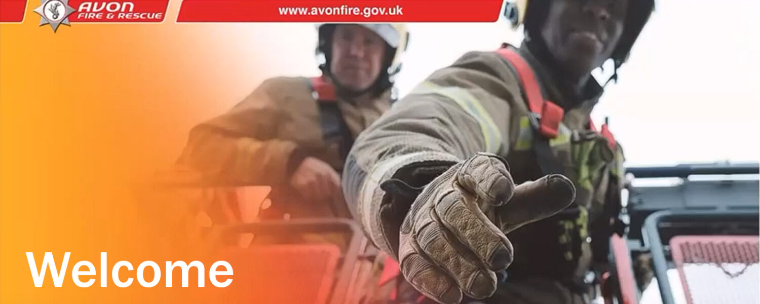 black firefighter holding out hand of help from crane with white firefighter behind looking at the camera