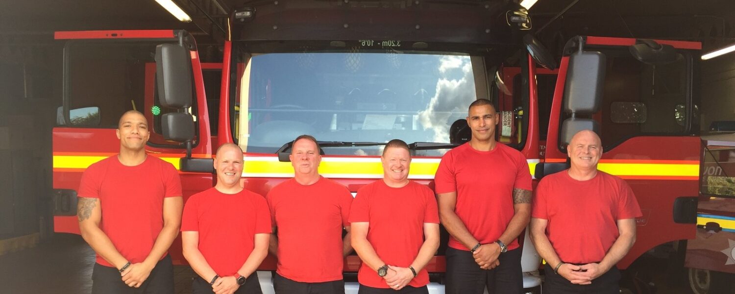 Crew of Firefighters outside a Fire engine