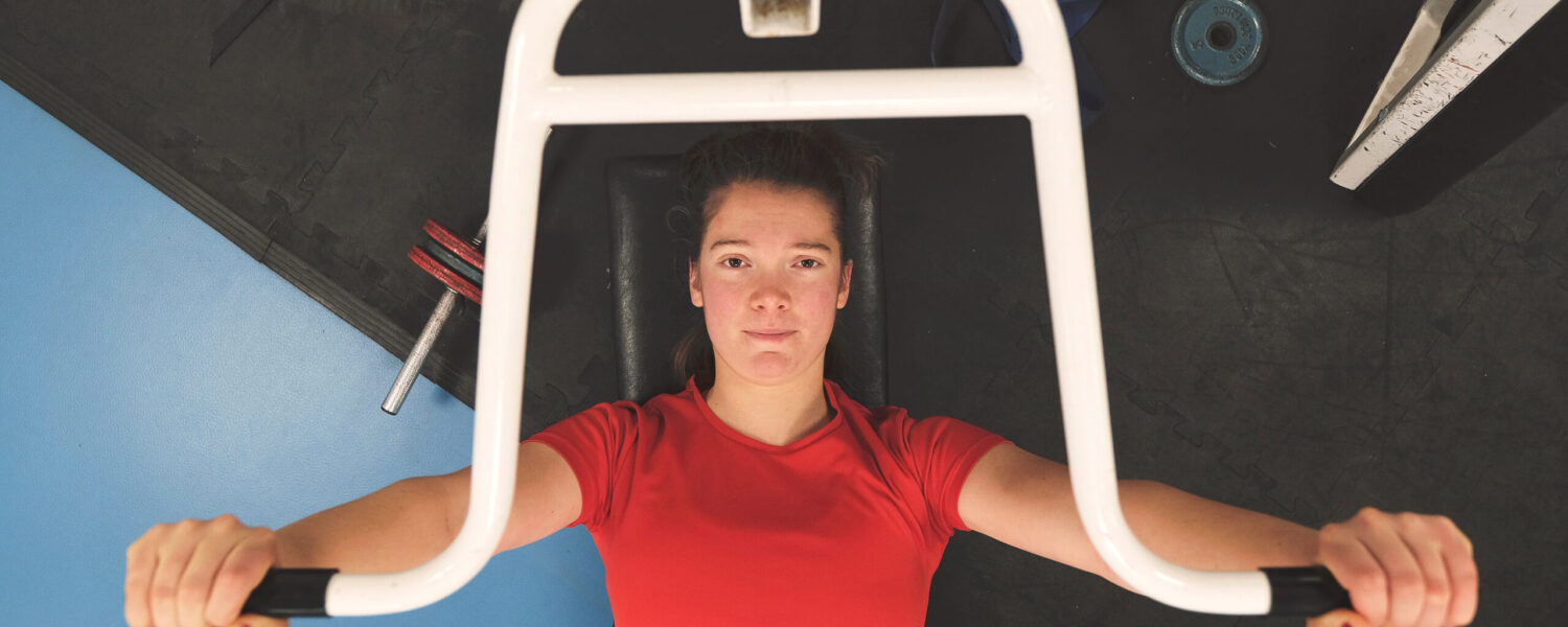 White Female Firefighter on exercise equipment