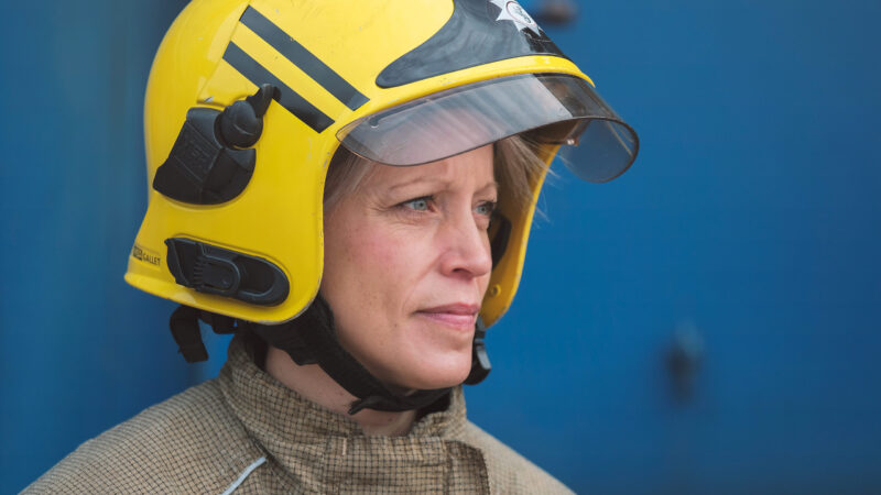 picture of a white female firefighter in full kit