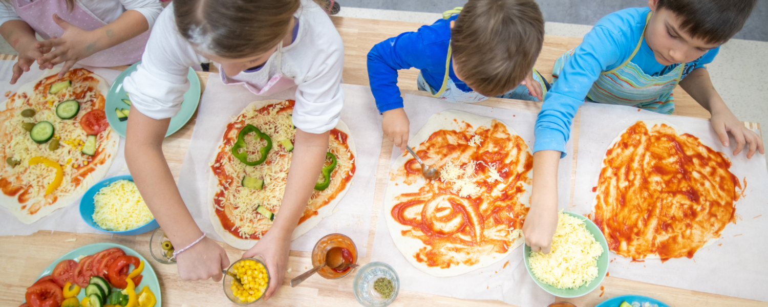 children making pizza in the kitchen