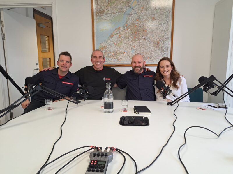 Four podcast hosts sat round a table.