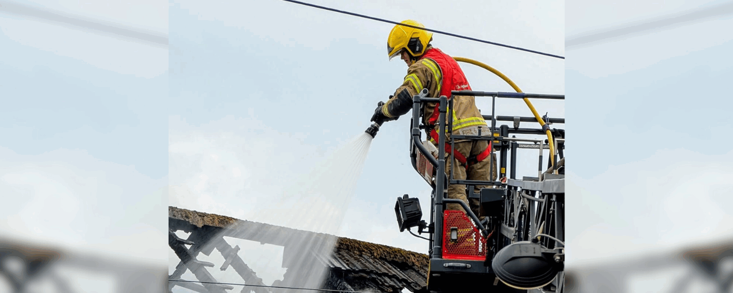 Firefighter putting out a house fire