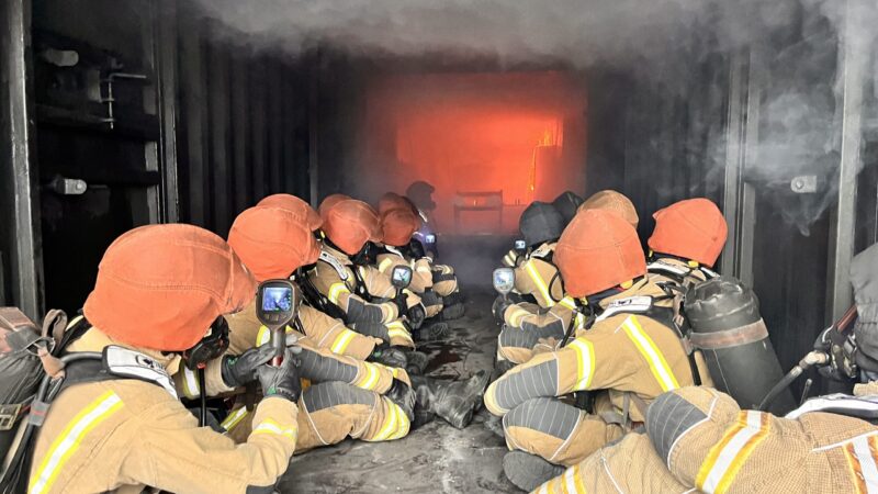 Wholetime firefighter recruits using thermal imaging cameras in hot fire training at Severn Park Training Centre
