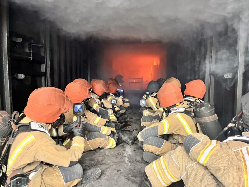 Wholetime firefighter recruits using thermal imaging cameras in hot fire training at Severn Park Training Centre