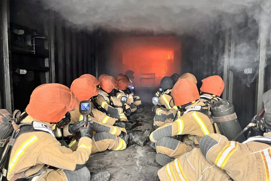 Wholetime firefighter recruits using thermal imaging cameras in hot fire training at Severn Park Training Centre