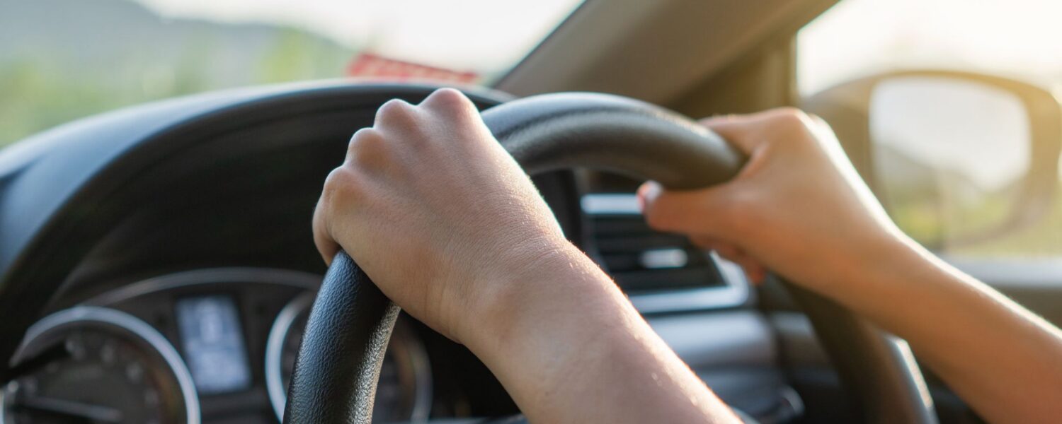 image of two hands holding a steering wheel