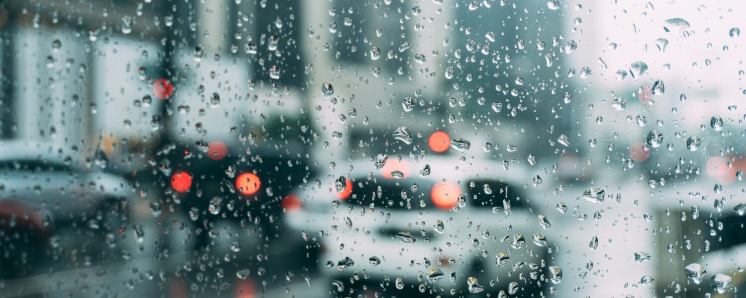 photo out of a car window driving through the rain.
