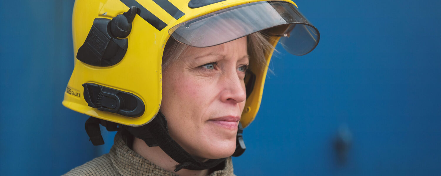 picture of a white female firefighter in full kit